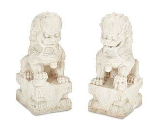 A pair of carved marble guardian lions