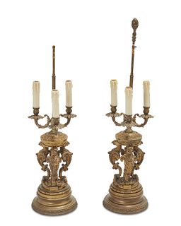 A pair of French gilt-bronze candlestick lamps