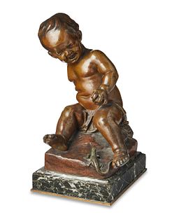 A French bronze sculpture of a boy with a lizard