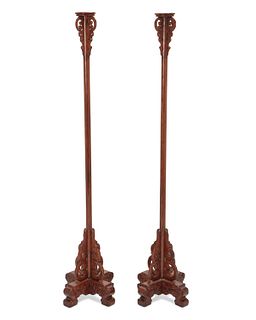 A pair of Chinese carved mahogany floor torchieres