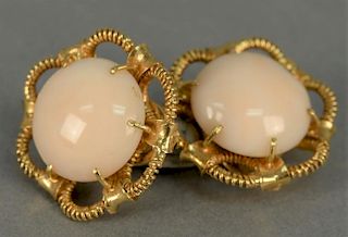 18K clip on earrings, each set with large cabochon cut light pink coral. 
total weight 18.4 grams