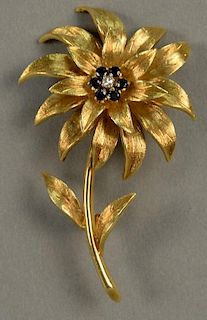 18K Tiffany brooch in form of flower set with six blue sapphires and a center diamond. 
ht. 2 1/4in. 
15.7 grams