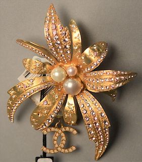 Large Chanel brooch/pin flower having three pearl center surrounded by gold leaves mounted with crystal and pink rhinestones,