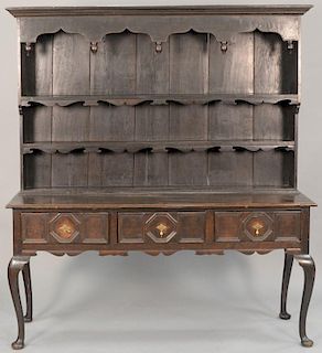 Oak Welsh cupboard in two parts, upper section having cornice molding over open shelves on lower section having three drawers