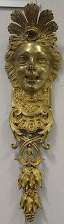 Pair of gilt bronze wall hangings with ladies face over scrollwork and leaves and grapes.  ht. 26 1/2in., wd. 7in.