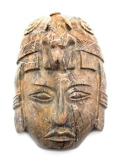 An Olmec Style Stone Mask, Height 10 1/2 inches.