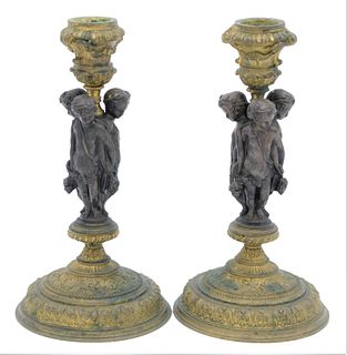 A Pair of Bronze and Gilt Bronze Figural Candlesticks