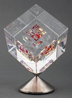 Jon Kuhn (American, b. 1949) "Ruby Sunset" Studio Art Glass sculpture comprised of a cube with red glass encased in a larger colorless cube, spinning 