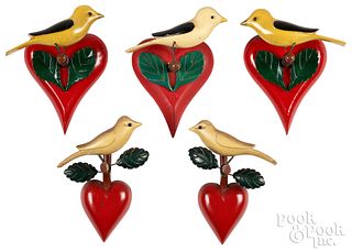 Five carved and painted birds on heart perches