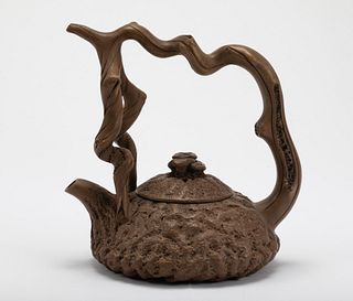 A Qing Dynasty purple clay teapot with a handle