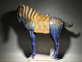 A magnificent large sancai-glazed figure of a caparisoned horse, Tang dynasty 