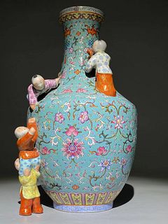 A turquoise-ground famille rose ?five boys? vase.