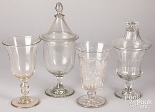 Four colorless glass vases