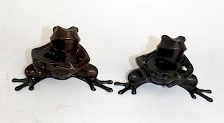 Pair of bronze frog candle holders.