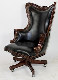 Carved mahogany swivel desk chair with leather