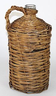 French wine bottle wrapped in wicker basket.
