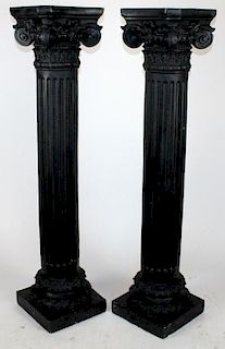 Pair of black Corinthian capped columns