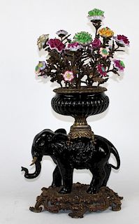 Painted bronze elephant with floral bouquet