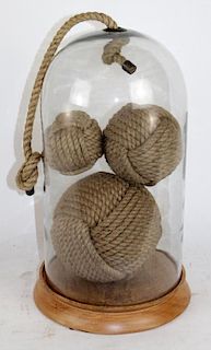 Nautical rope balls in glass dome display