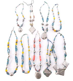 Nine Strands of Trade Beads and Metallic Pendants