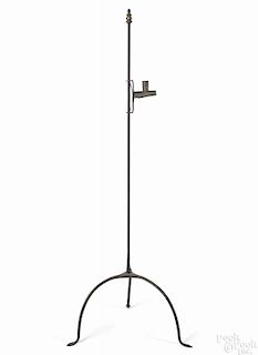 Wrought iron floor standing candlestand, 19th c., with an adjustable tin candlecup, 49'' h.