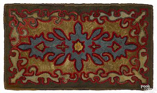 American geometric hooked rug, ca. 1900, with scrolled panels, 54'' x 32''.