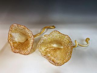 TWO ART GLASS FLOWERS WITH TWISTED STEMS