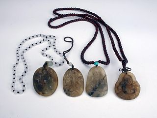FOUR CARVED JADE BUDDHA PENDANTS STRUNG ON BEADS