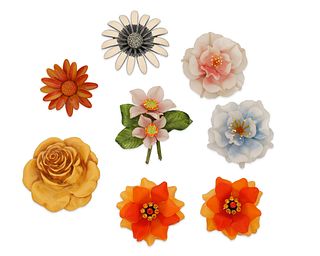 A group of floral brooches