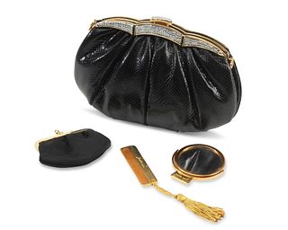 A Judith Lieber black snake leather purse