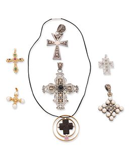 A group of sterling silver and gold cross pendants