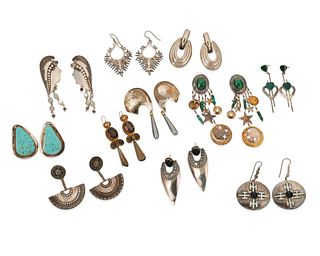 A large group of silver earrings