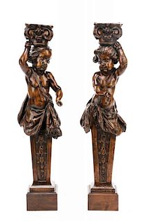 *Pair of Carved Walnut Figural Cherub Pedestals