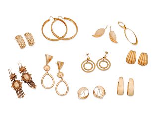 A group of gold earrings