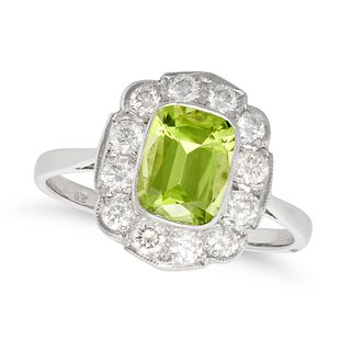 A PERIDOT AND DIAMOND CLUSTER RING in platinum, set with a cushion cut peridot of approximately 1...