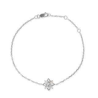 A DIAMOND BRACELET in 18ct white gold, comprising a stylised star motif set with round brilliant ...