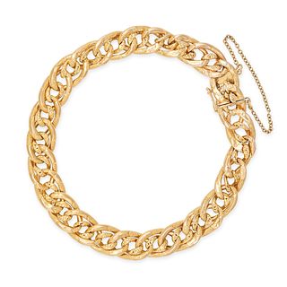 A CURB LINK BRACELET in 18ct yellow gold, comprising a row of interlocking engraved curb links, s...