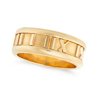 TIFFANY & CO., AN ATLAS RING, 1995 in 18ct yellow gold, set around the band with Roman numerals, ...