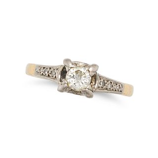 A DIAMOND RING in 18ct yellow gold, set with a round brilliant cut diamond, the shoulders set wit...