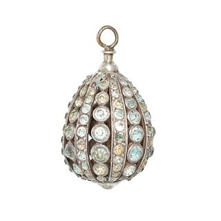 AN ANTIQUE PASTE EGG PENDANT designed as an egg, the open work body set throughout with blue and ...