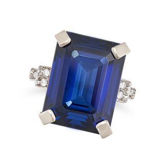 A SYNTHETIC SAPPHIRE AND DIAMOND RING in 9ct yellow gold, set with an octagonal step cut syntheti...