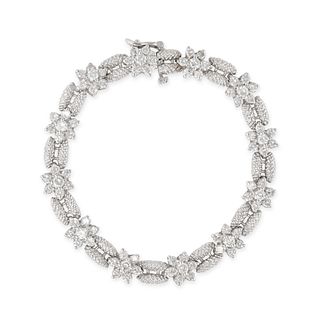 A DIAMOND BRACELET in 14ct white gold, comprising twelve floral clusters, set with round brillian...
