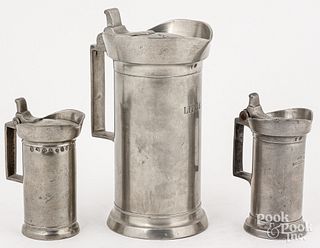 Three French pewter lidded measures, mid 19th c.