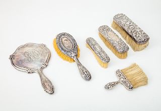 American Monogrammed Silver Hand Mirror and Five Repoussé-Decorated Brush Backs