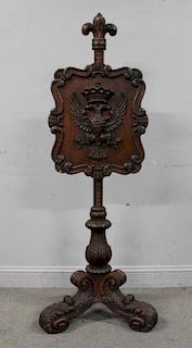 A Carved Pedestal and Shield Fire Screen.