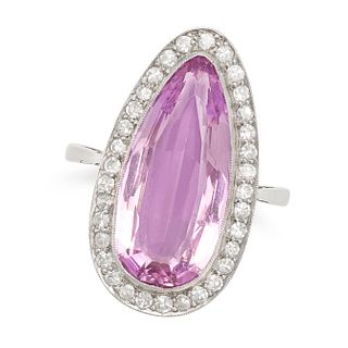 A PINK TOPAZ AND DIAMOND RING in platinum, set with a pear cut pink topaz of 7.11 carats within a...