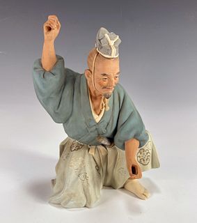 ROBED FIGURE IN WARRIOR POSE