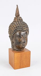 Buddha head on wooden base, Thailan