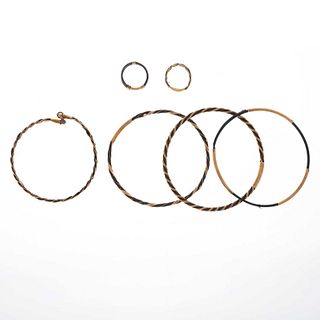Cuatro pulseras y dos anillos en metal base dorado y pelo de elefante. Peso: 15.6 g.