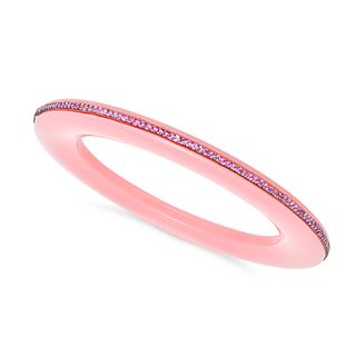 A PINK SAPPHIRE BANGLE comprising a pink plastic bangle accented by a row of round cut pink sapph...